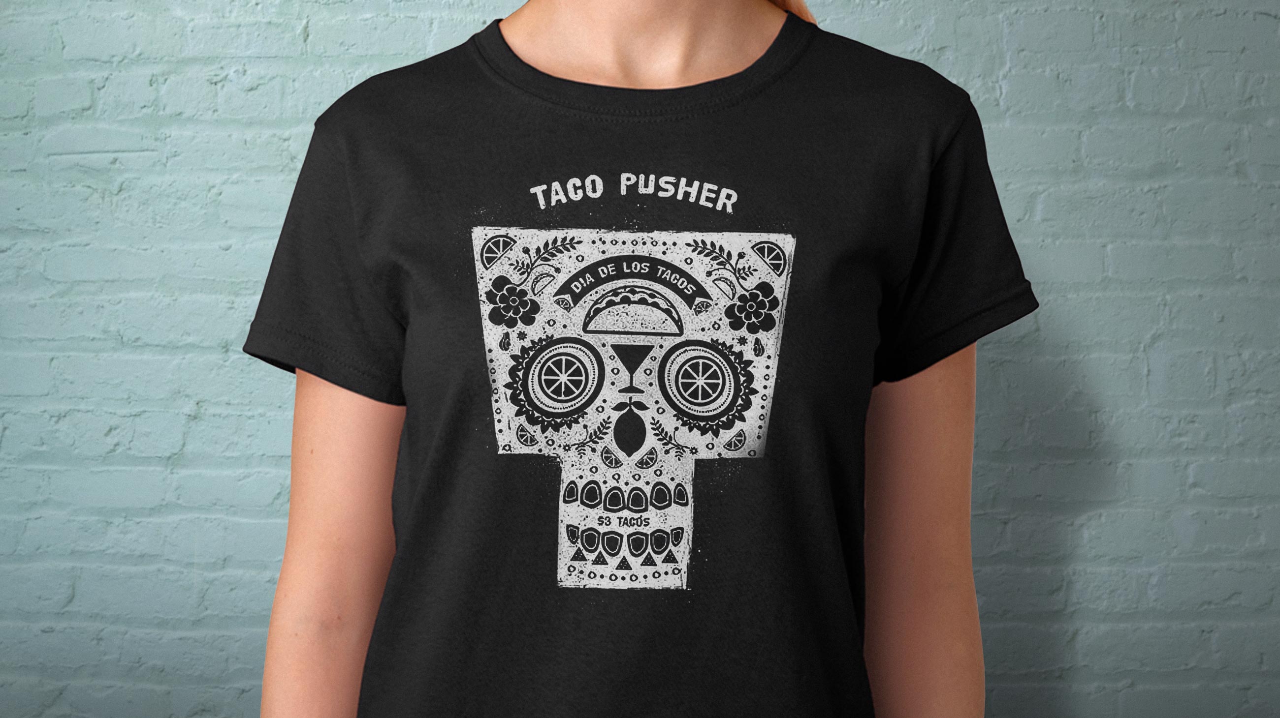 Server wearing black taco pusher t-shirt