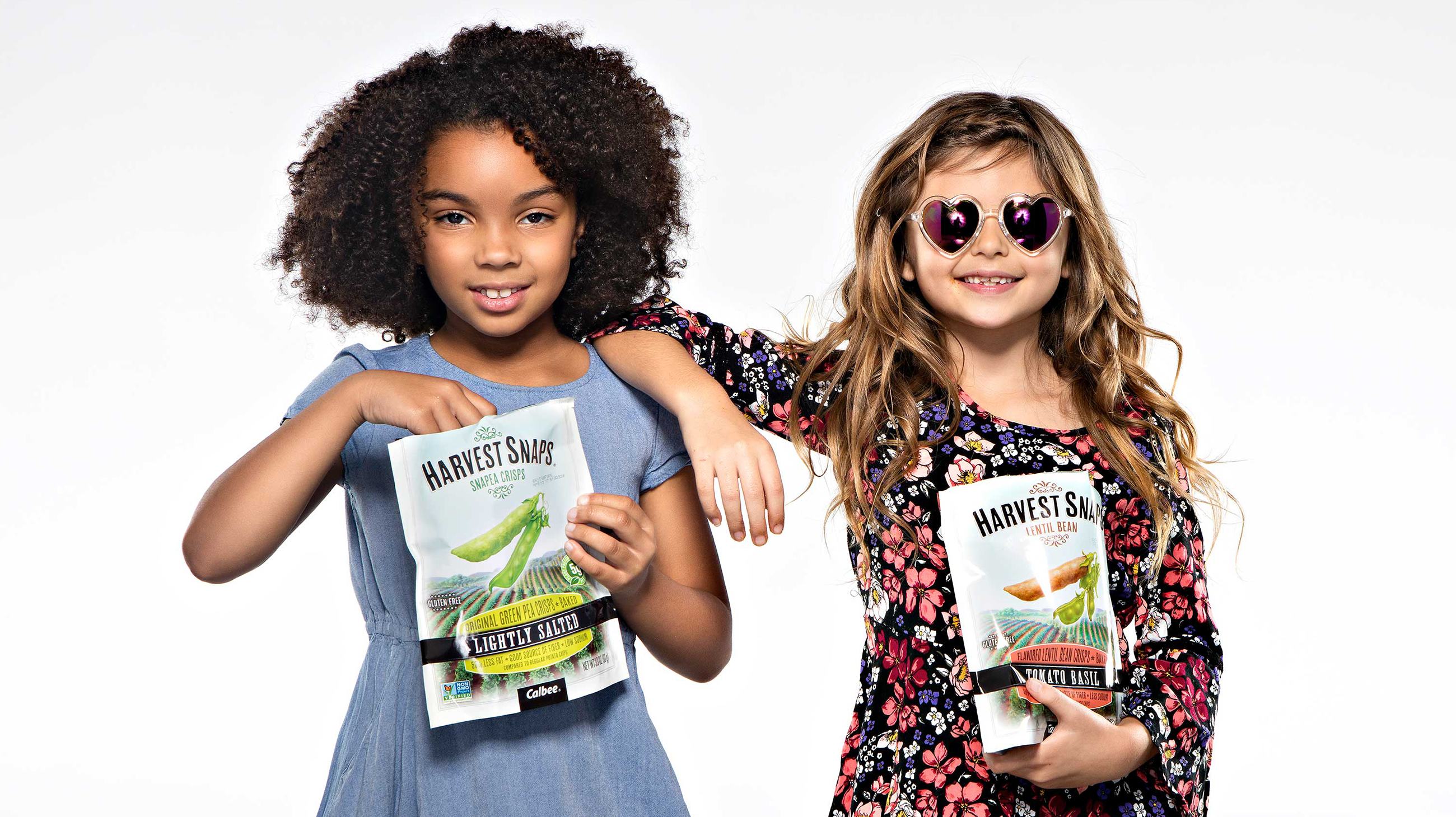 2 young girls acting cool eating harvest snaps
