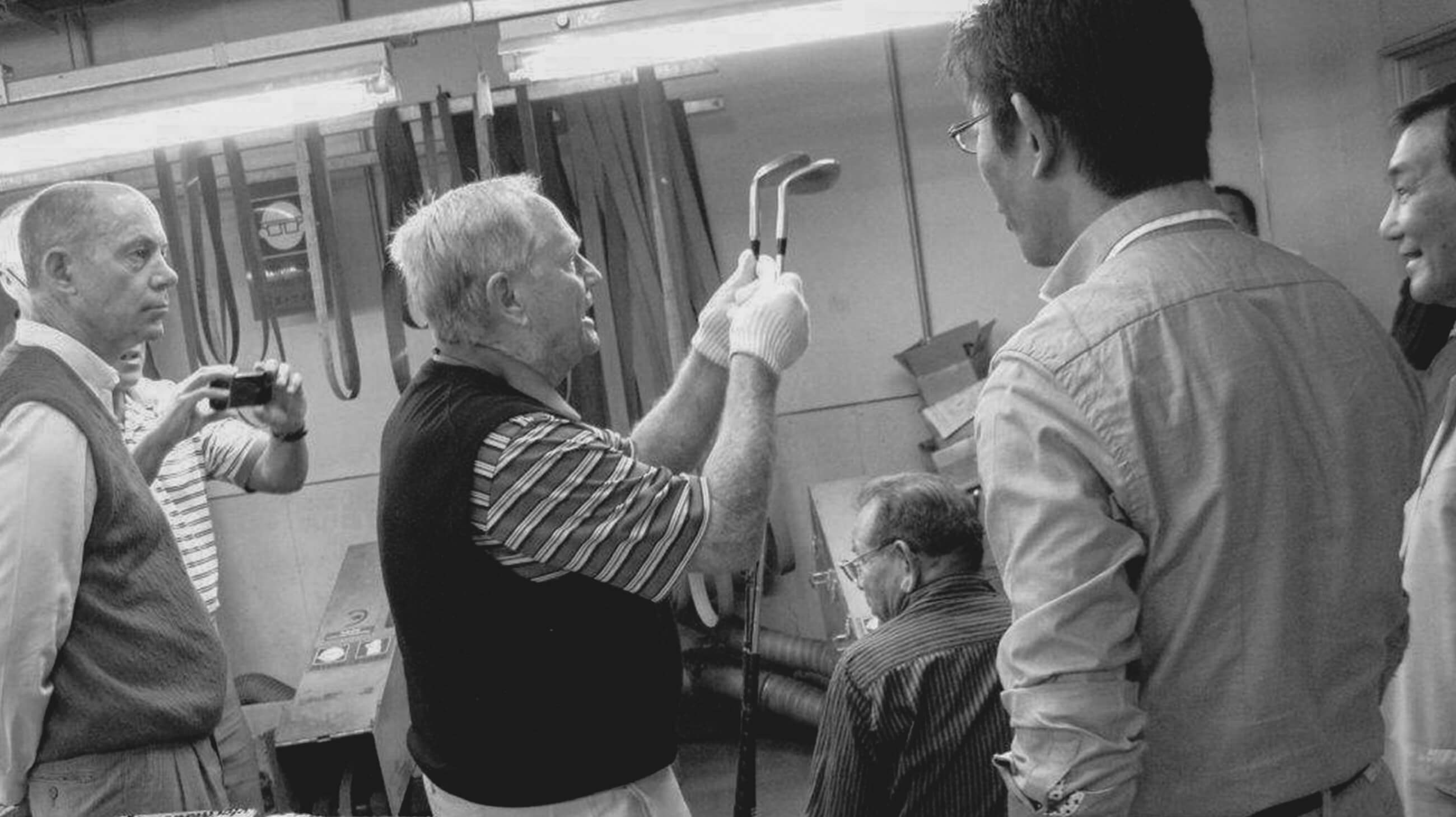 Jack Nicklaus holding two golf clubs