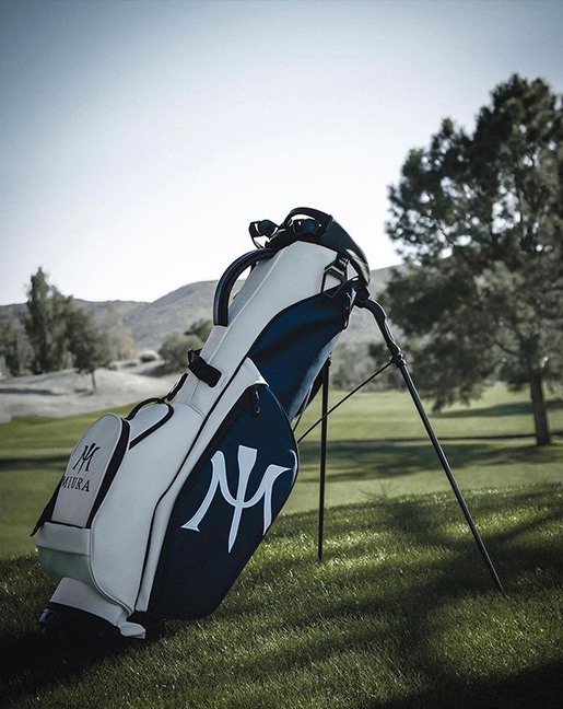 navy and white miura golf bag on golf course