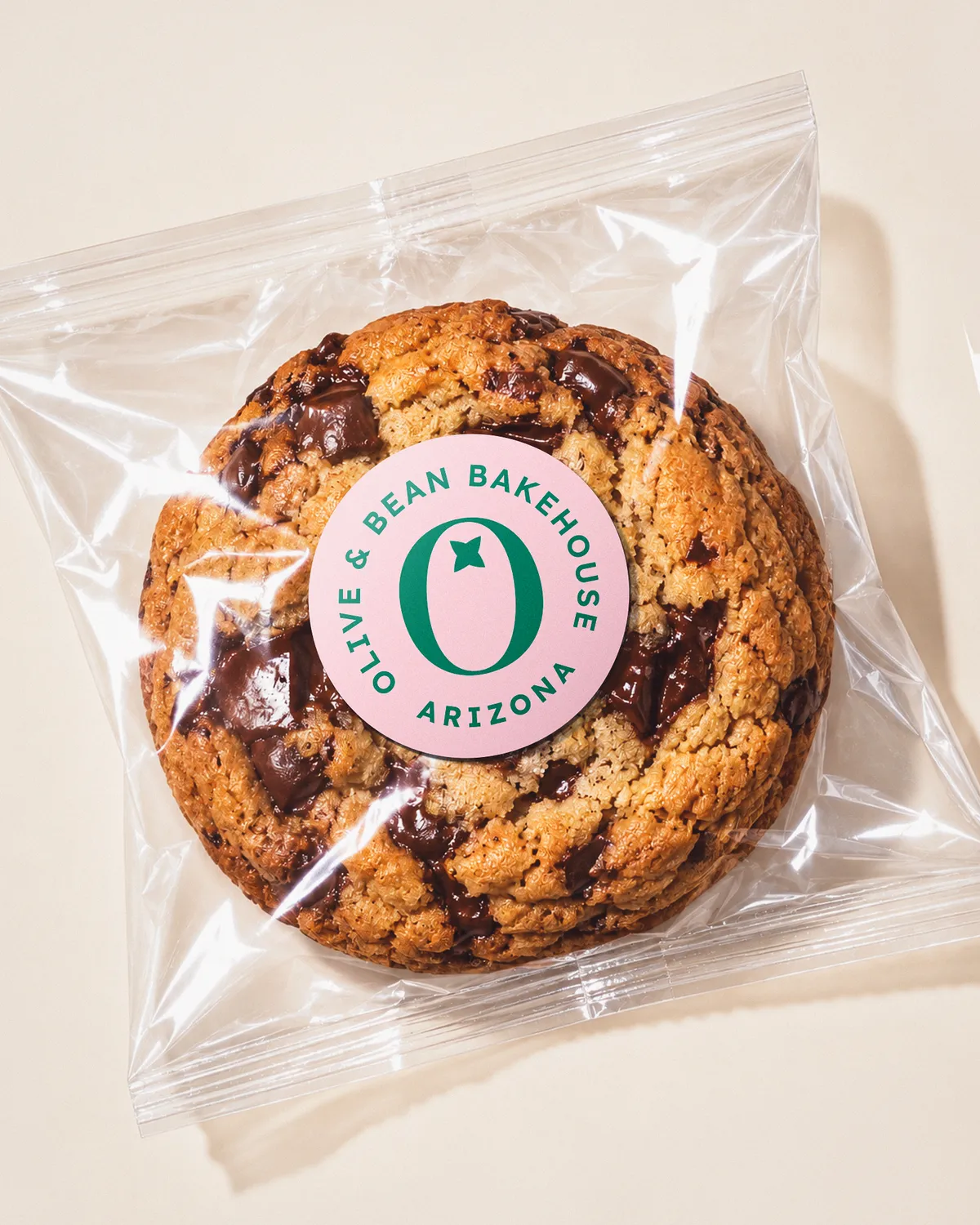 Chocolate chip cookie in a bag with the Olive & Bean Bakehouse sticker